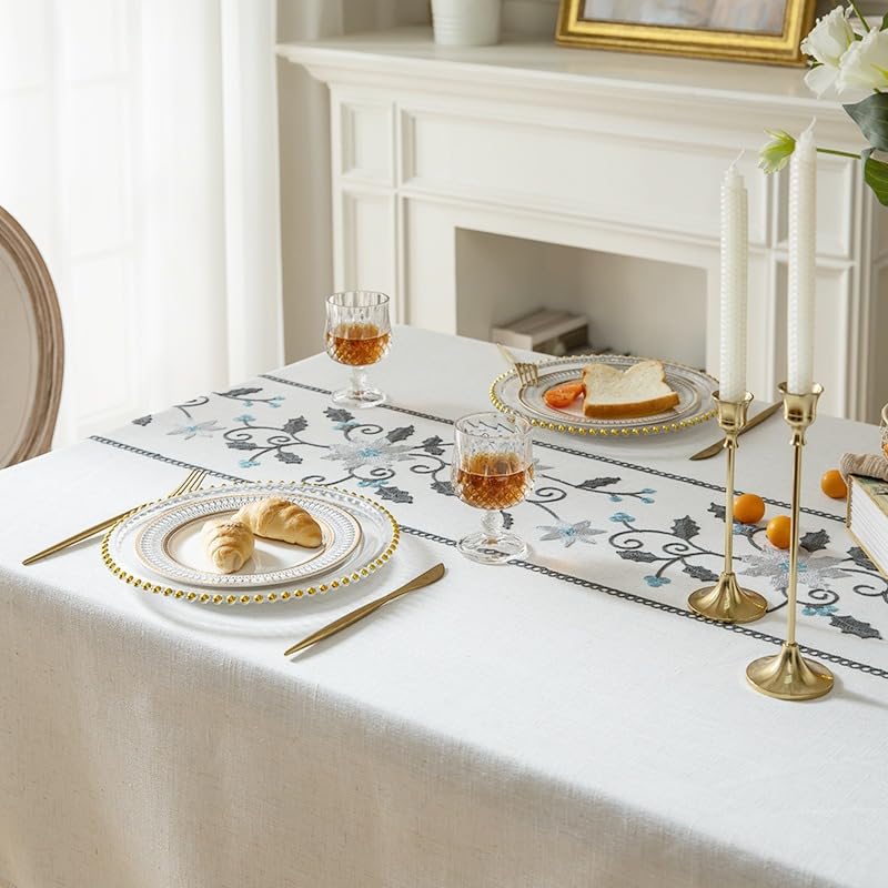 Dining setting detail with blue floral embroidered tablecloth
