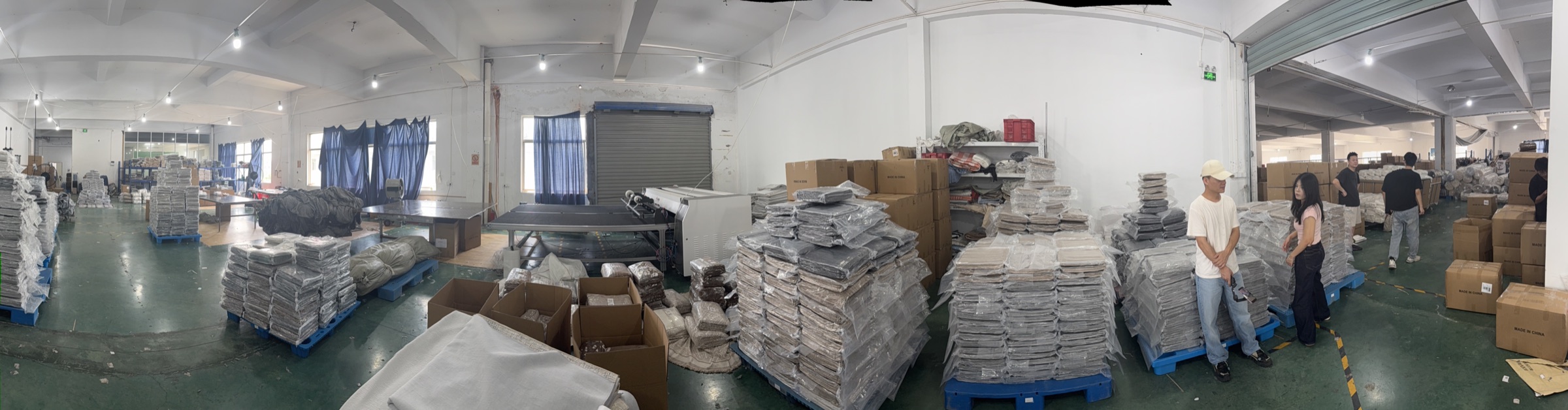 Finished sofa-cover inventory organized on pallets in the BOYA warehouse