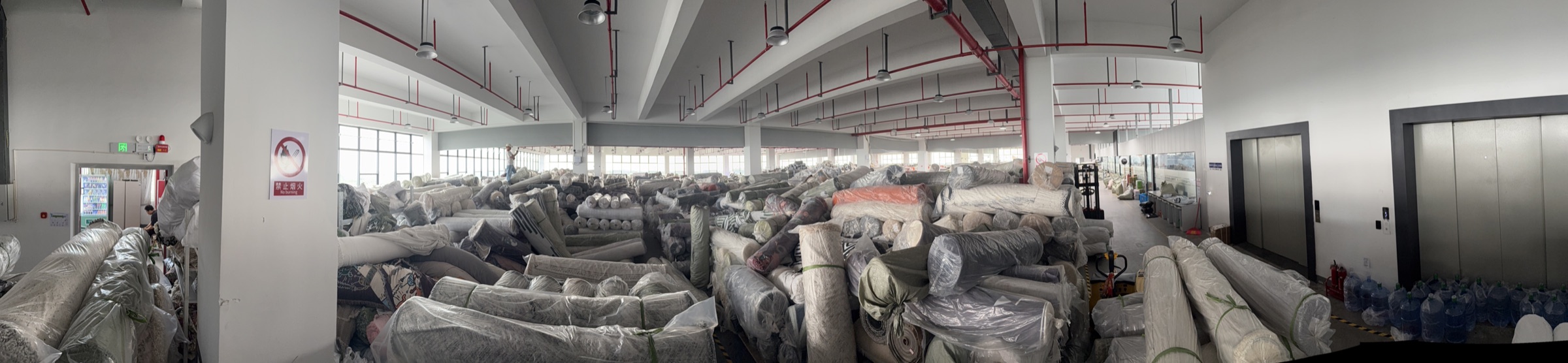 Panoramic view of packaged textile roll warehouse