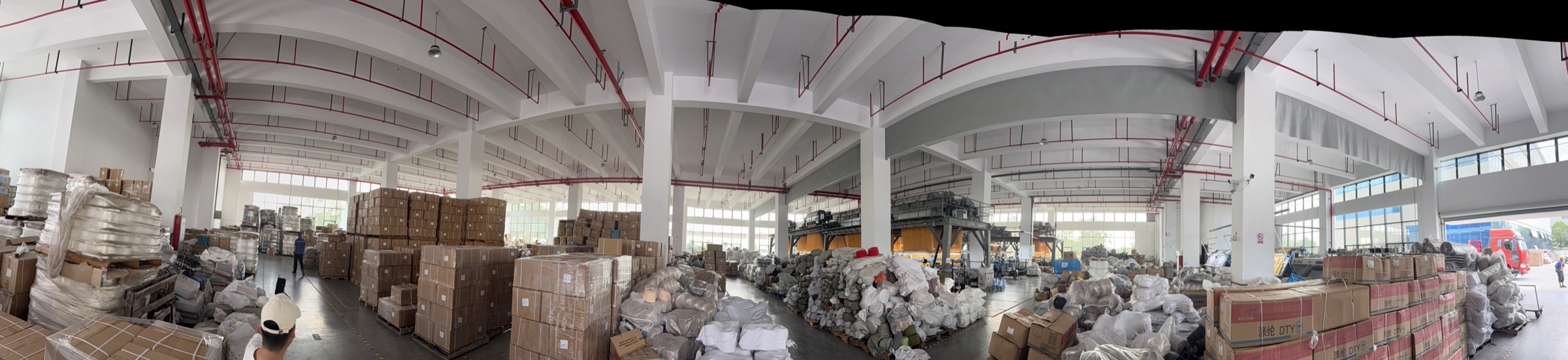 Warehouse loading area with packed cartons and textile inventory